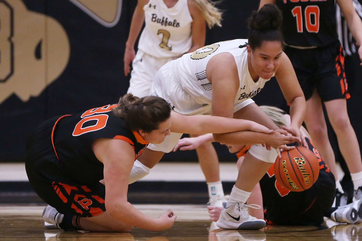 Danica Boyce dives to steal a ball from Powell senior Rylynn Valdez
